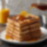 Golden-brown French toast waffles stacked on a plate with syrup drizzle