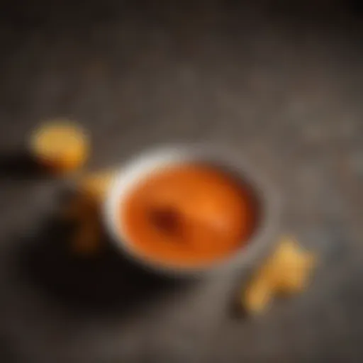 A rich bowl of mild buffalo sauce with a vibrant orange hue