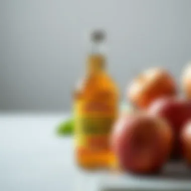A bottle of apple cider vinegar with fresh apples