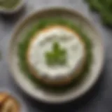 A creamy ricotta cheese spread on a plate with fresh herbs.