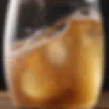 A close-up view of a glass of kombucha with bubbles rising