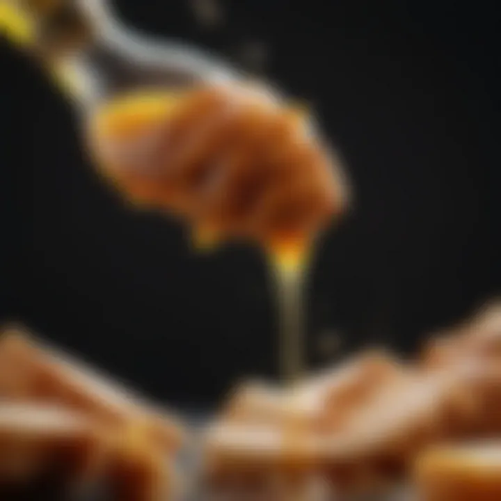 Close-up of honey being poured over chicken pieces