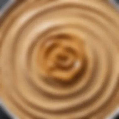 Peanut Butter in Hummus A close-up view of peanut butter being added to a creamy hummus mixture.