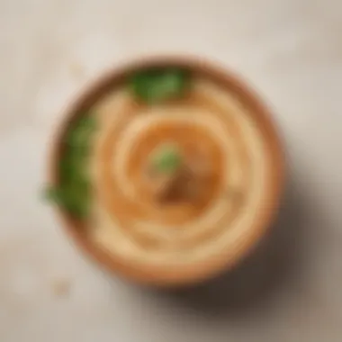 Garnished Hummus with Peanut Butter A vibrant hummus bowl garnished with fresh herbs and peanut butter drizzle.