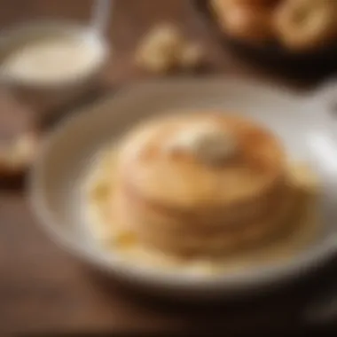 A bowl filled with creamy pancake batter beside a whisk