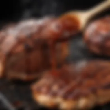 A close-up view of smoky, flavorful barbecue sauce being brushed onto grilled meat.