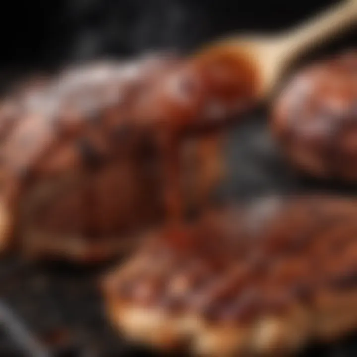 A close-up view of smoky, flavorful barbecue sauce being brushed onto grilled meat.