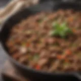 Sizzling skillet of seasoned ground beef with herbs