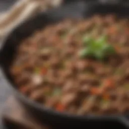 Sizzling skillet of seasoned ground beef with herbs